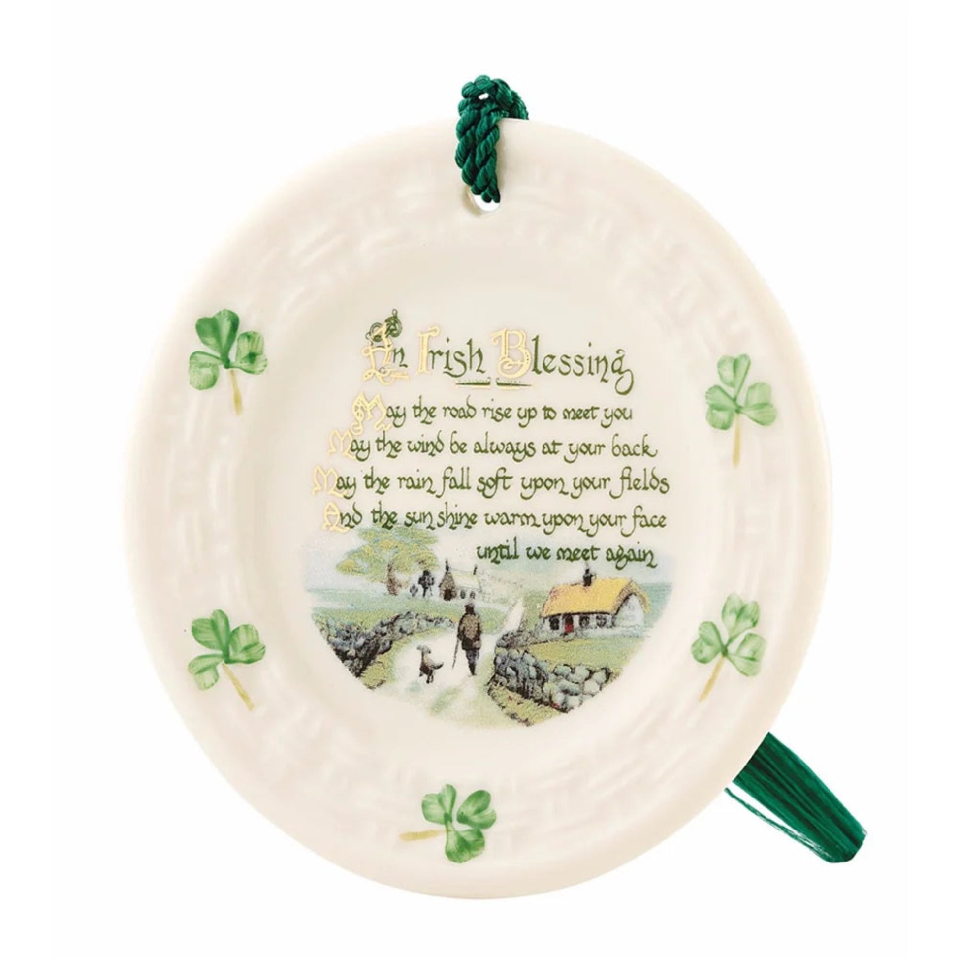 Plate ornament with a painting of the Irish countryside and green lettering. Green shamrocks on the rim. 