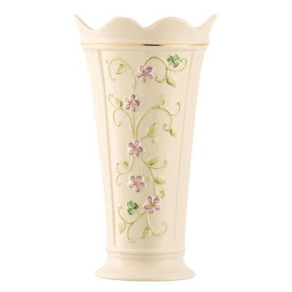 Cream-colored vase with floral designs on a white background