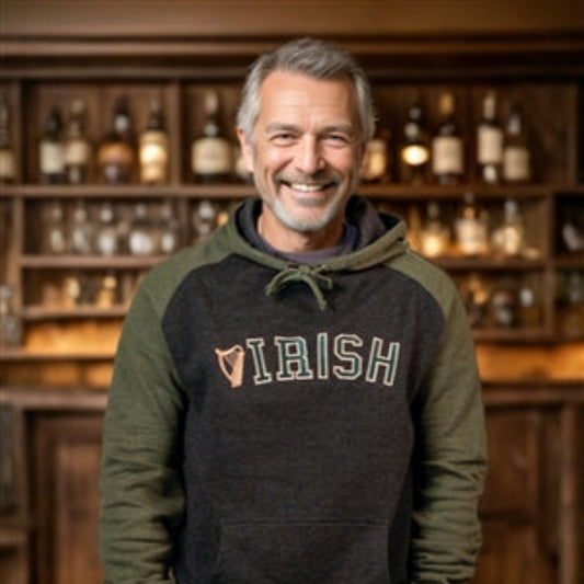 Man wearing a hoodie with 'Irish' text in a bar setting