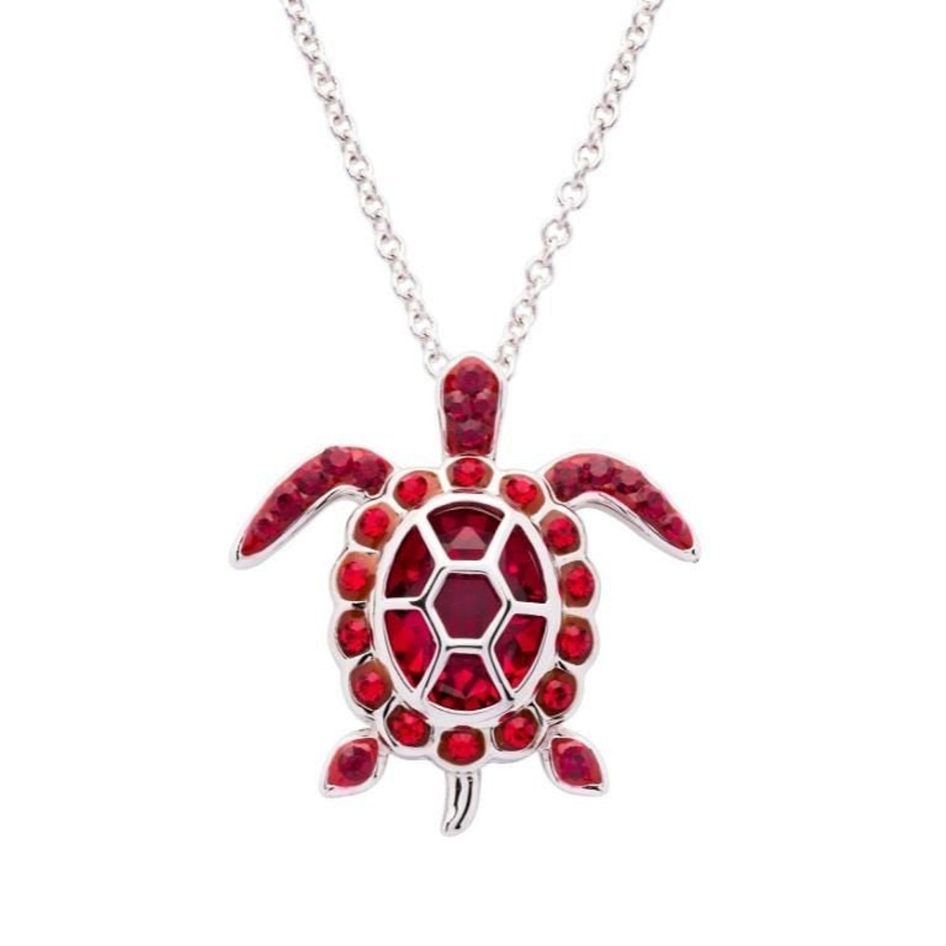 Turtle-shaped pendant with red gemstones on a silver chain against a white background