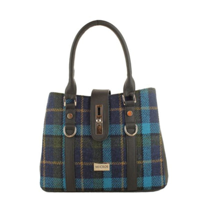 Blue and green plaid handbag with black straps on a white background