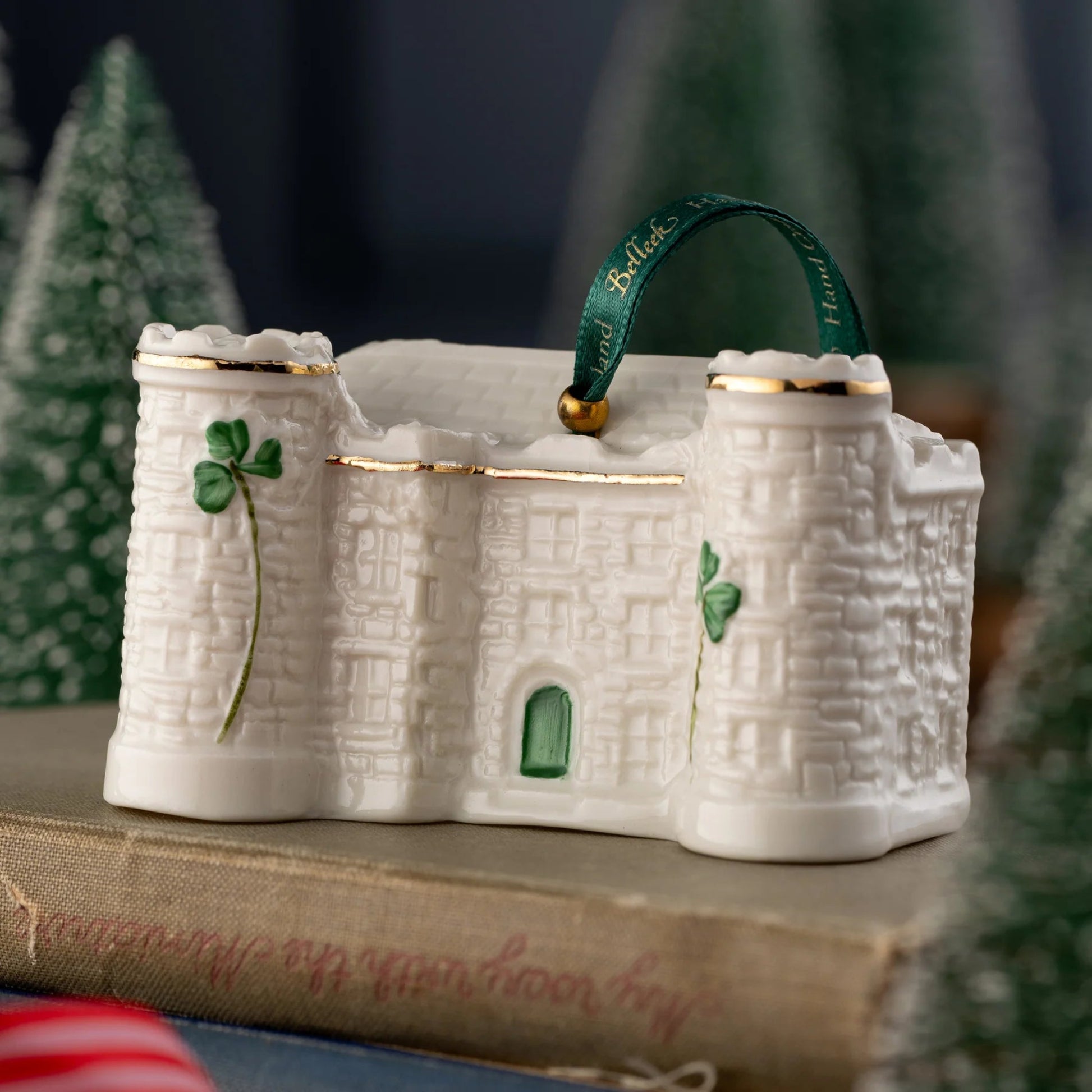 Porcelain castle ornament with gold detailing and green shamrocks.