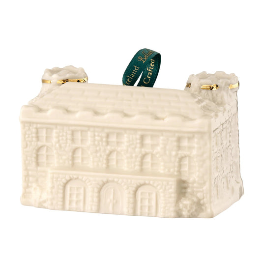 Castle-shaped porcelain ornament with golden detailing and a green ribbon hook.