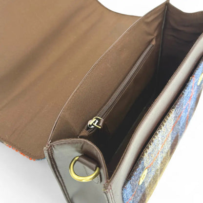 Open brown handbag with a colorful interior on a white background