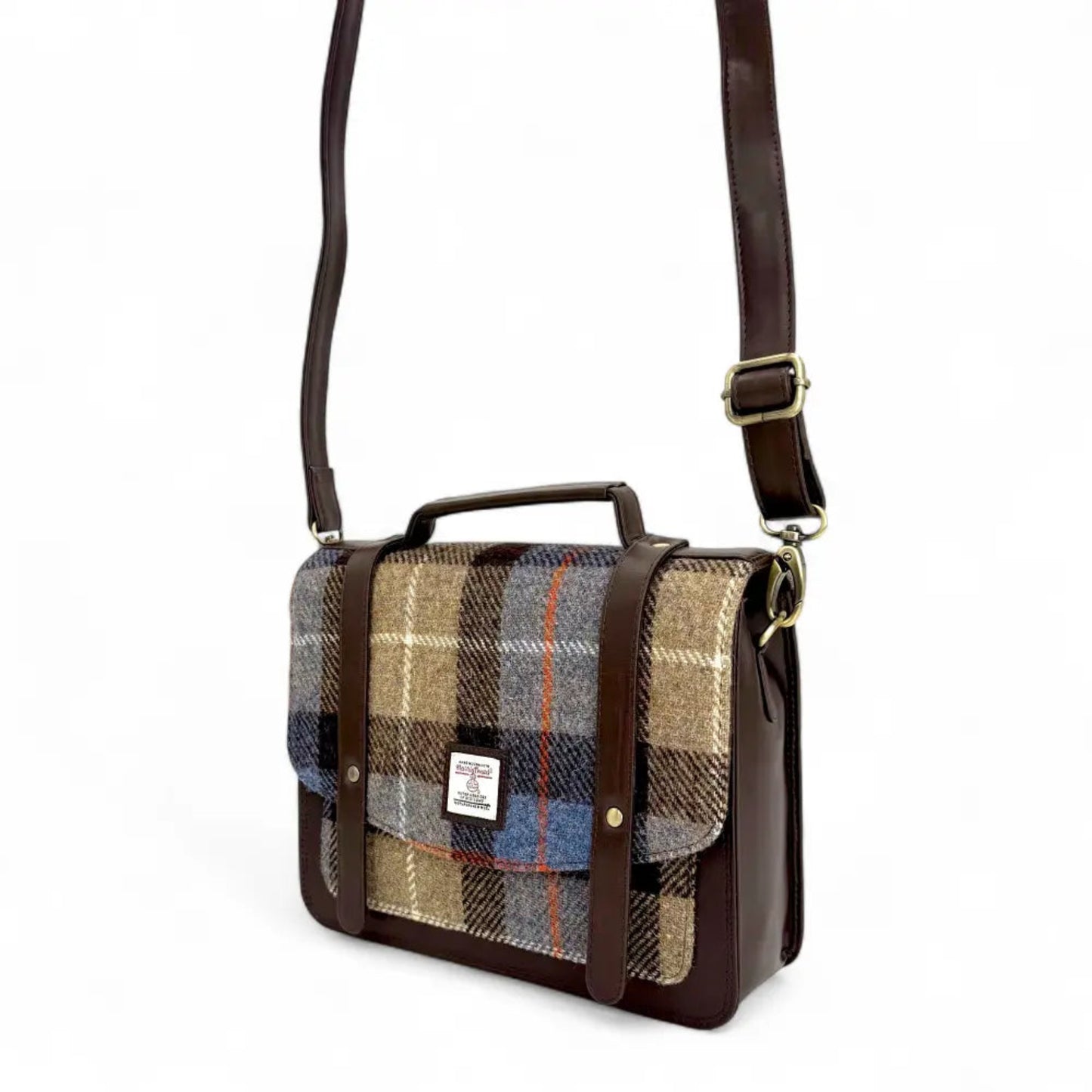 Plaid patterned bag with brown leather accents on a white background