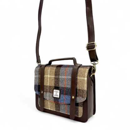 Plaid patterned bag with brown leather accents on a white background