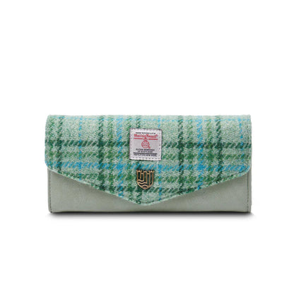 Woven clutch bag with green and blue plaid pattern on a white background