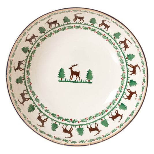 Decorative plate with reindeer and tree design on a white background