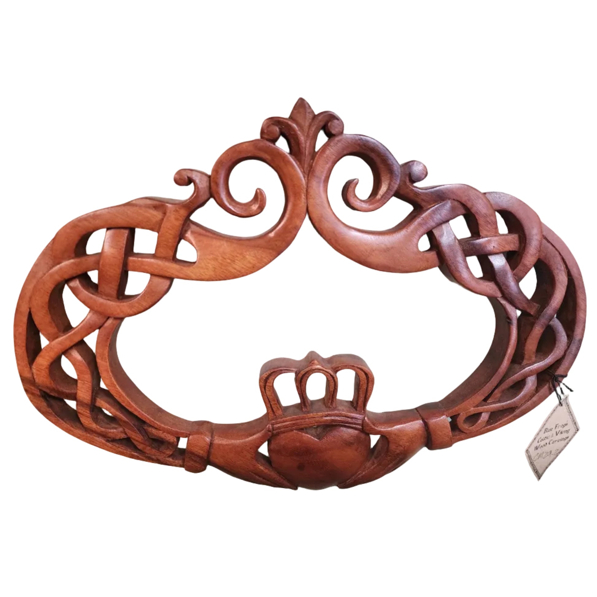 A wooden carving of the Claddagh symbol, featuring intricate designs and a heart shape.