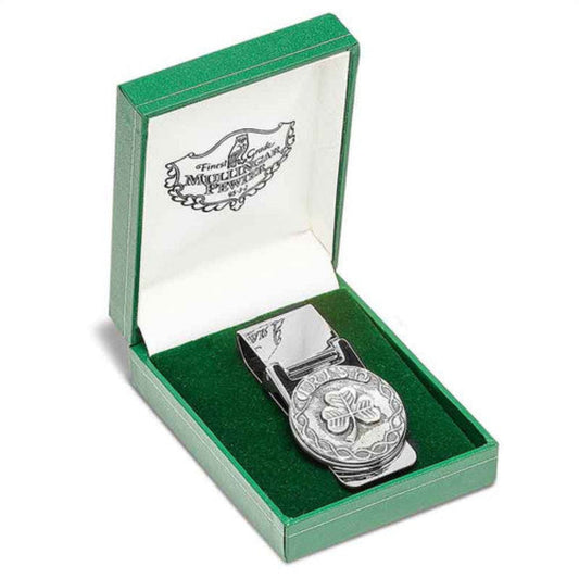 A silver-colored money clip with a shamrock design bordered by celtic knotwork and the word "Irish." Sitting in a green felt box.