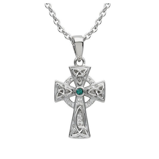 Silver cross pendant with emerald and diamonds on a white background