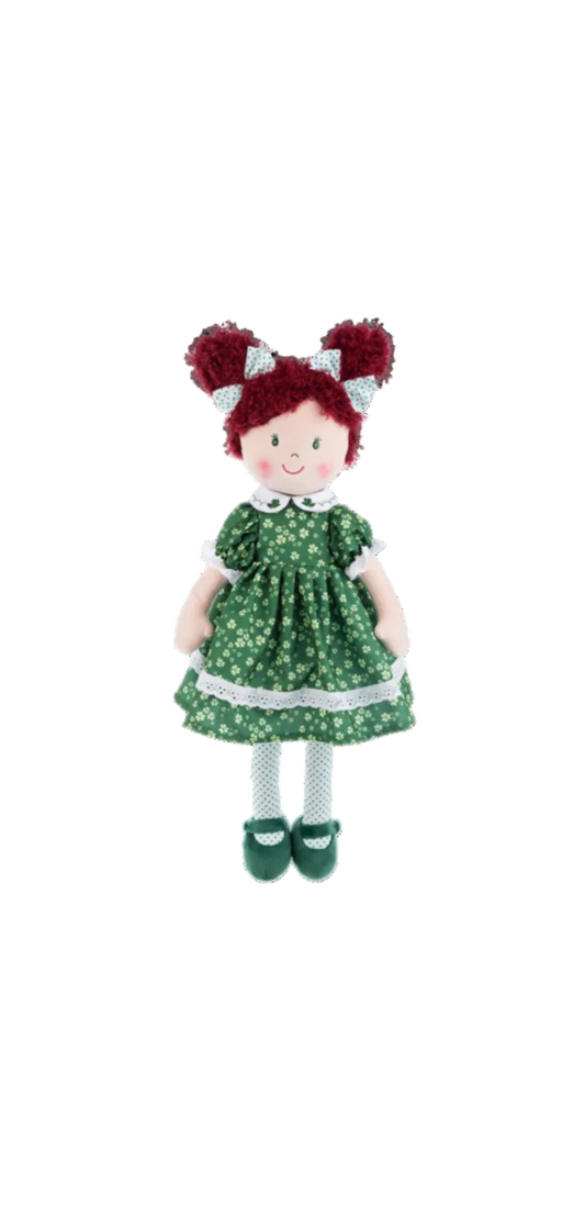 Toy doll with red hair in buns wearing a green dress with white floral pattern on a white background