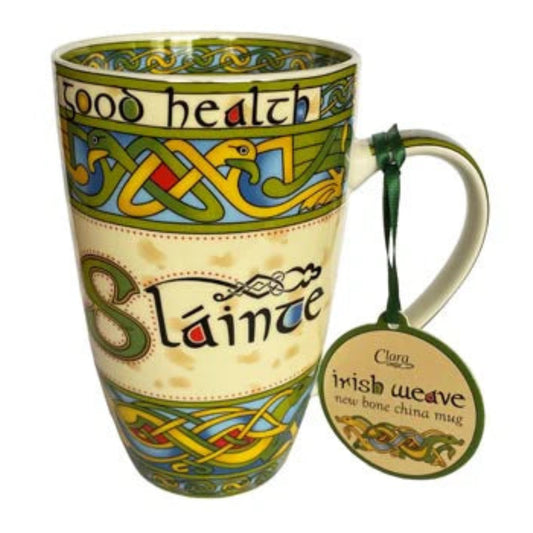 Mug with colorful Celtic knotwork designs and the word "Slainte" stylized in the center. 
