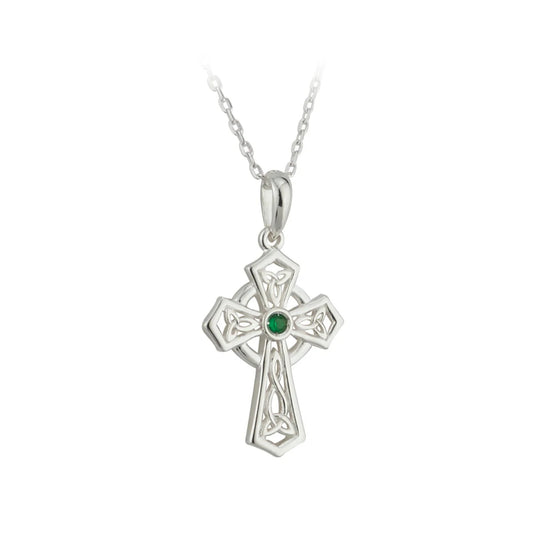 Silver cross pendant with a green gemstone on a white background