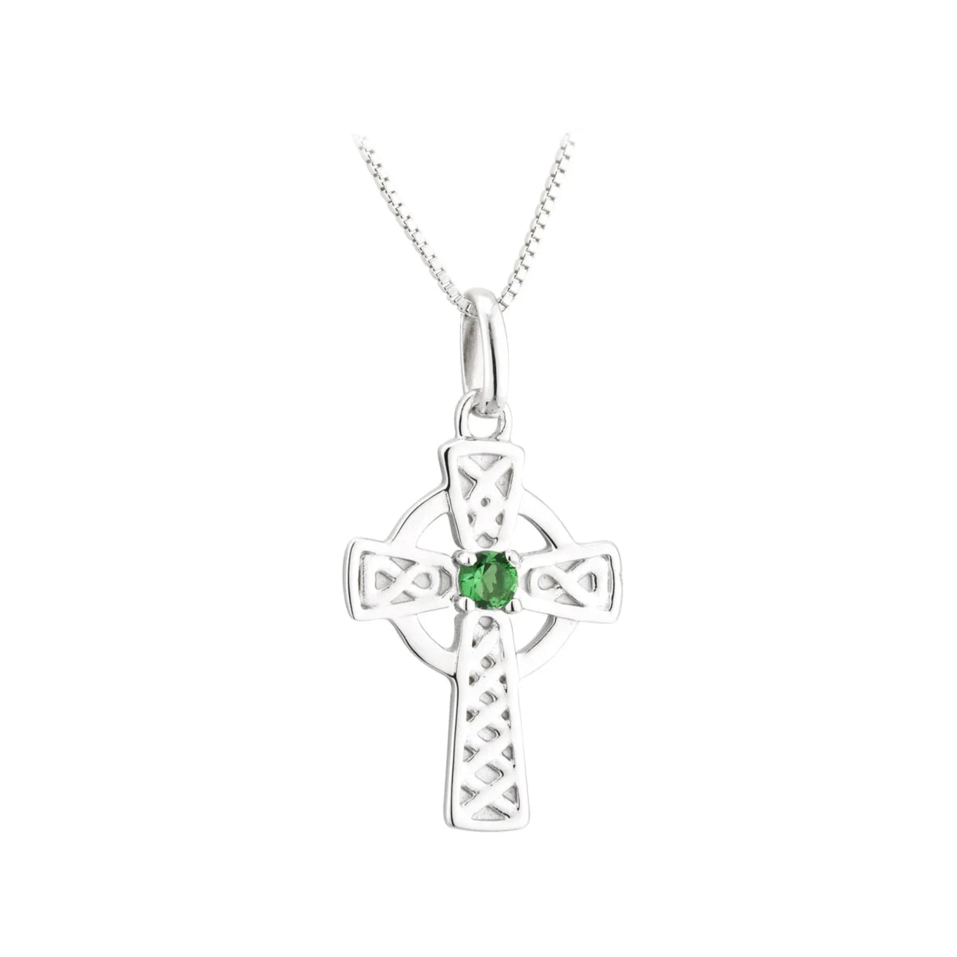 Silver cross pendant with a green gemstone on a white background