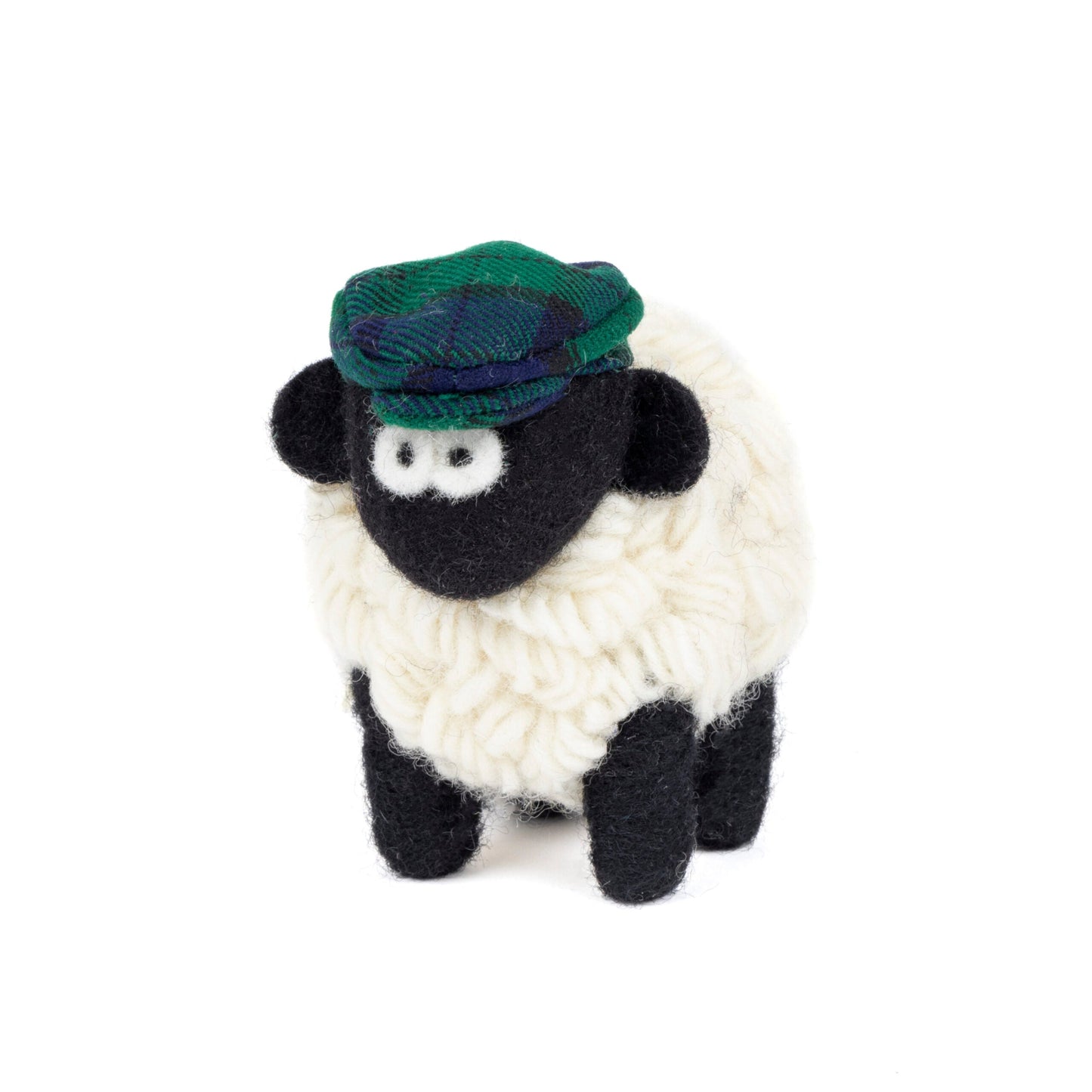 Knitted sheep toy with a green tartan hat on a white background