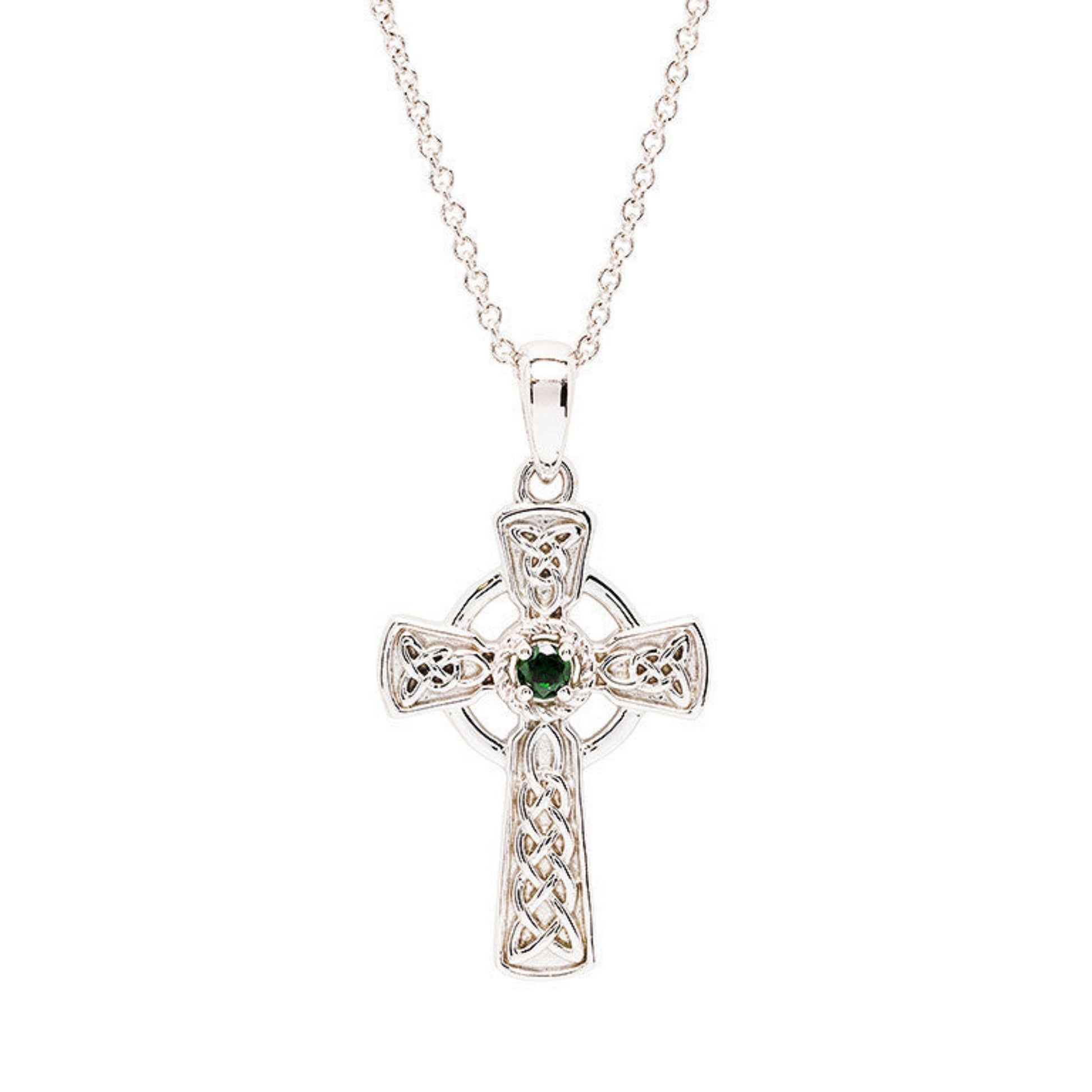 Silver Celtic cross pendant with a green gemstone on a white background