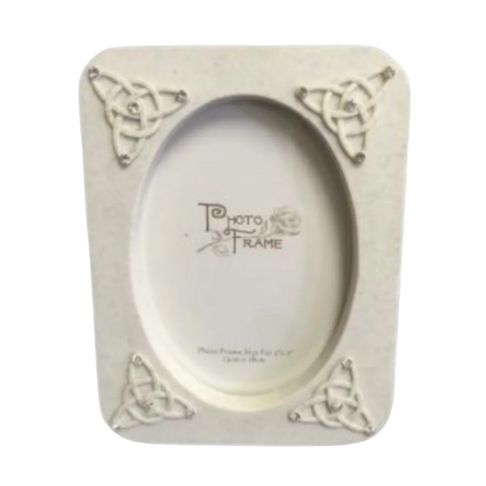 Decorative photo frame with Celtic knot designs on a white background