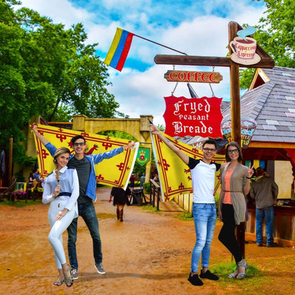 Two couples posing with large scottish lion flags.