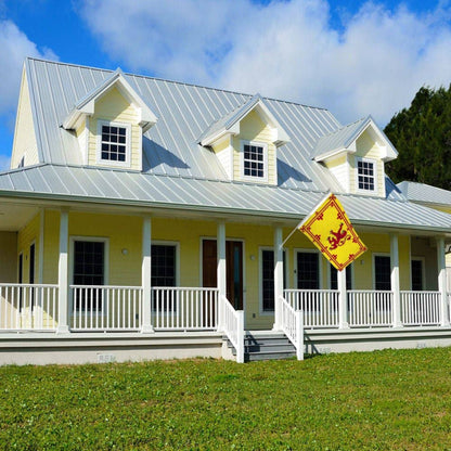Yellow house with a white porch flying a yellow Scottish lion flag. 