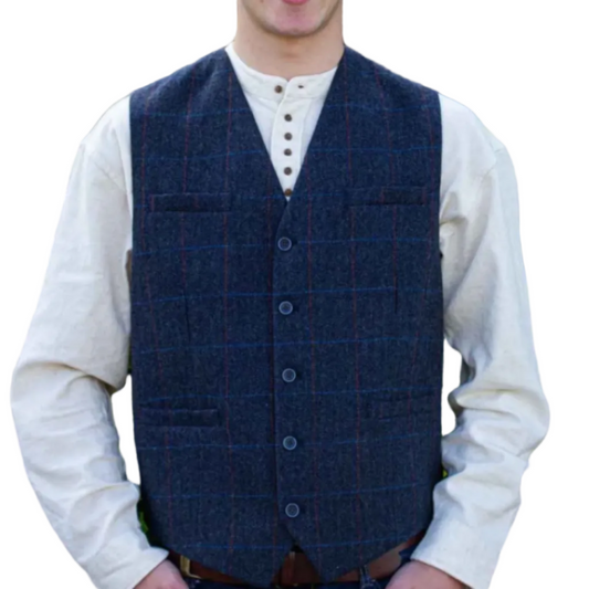Man wearing a blue tweed overcoat with subtle stripes over a white long-sleeved Irish shirt.