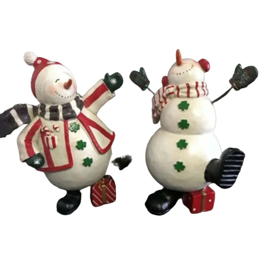 Two decorative snowman figurines with festive clothing in dancing positions