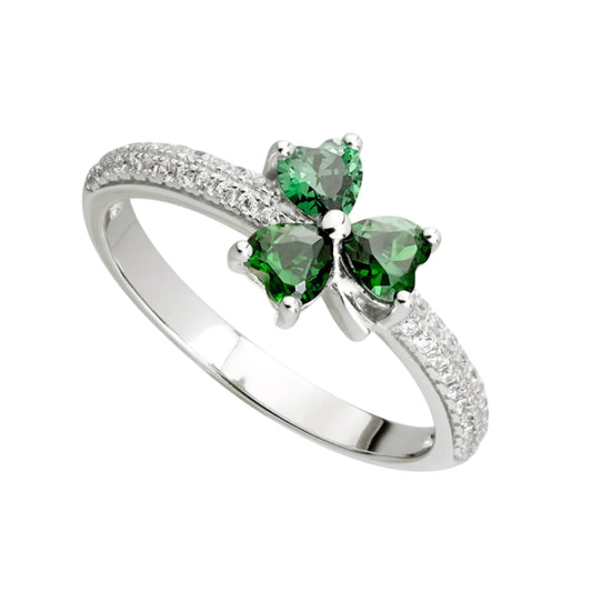 A sterling silver ring with three green, shiny stones set in the shape of a shamrock. The rest of the top half of the ring features dozens of clear white accent stones set in two rows.