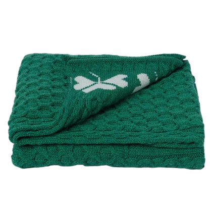 Folded green towel with a white logo on a white background