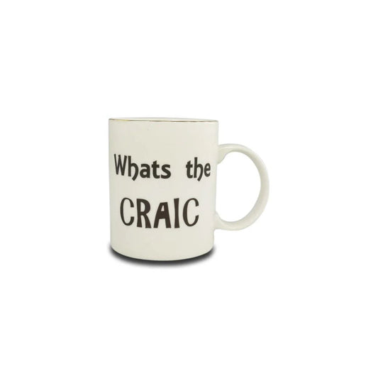 White mug that says "what's the craic" in black text.