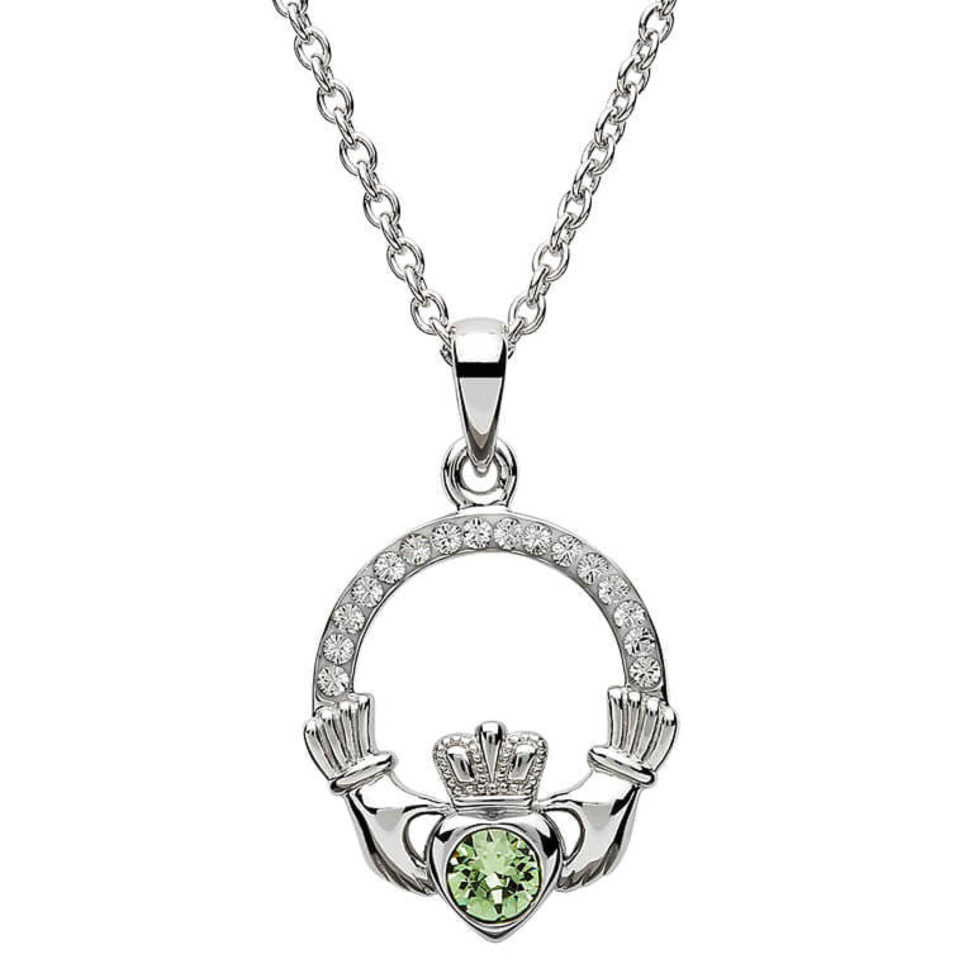 Silver claddagh pendant encrusted with white gems. The heart in the center contains one larger mint green gem. 