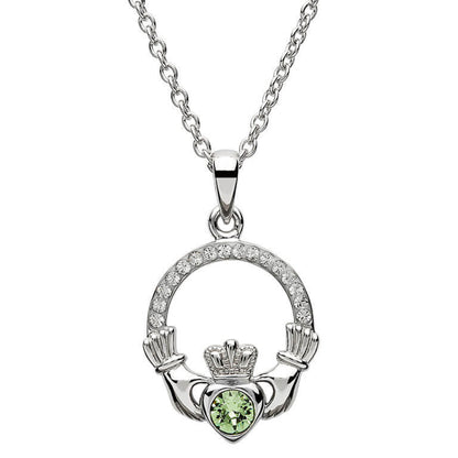 Silver claddagh pendant encrusted with white gems. The heart in the center contains one larger mint green gem. 