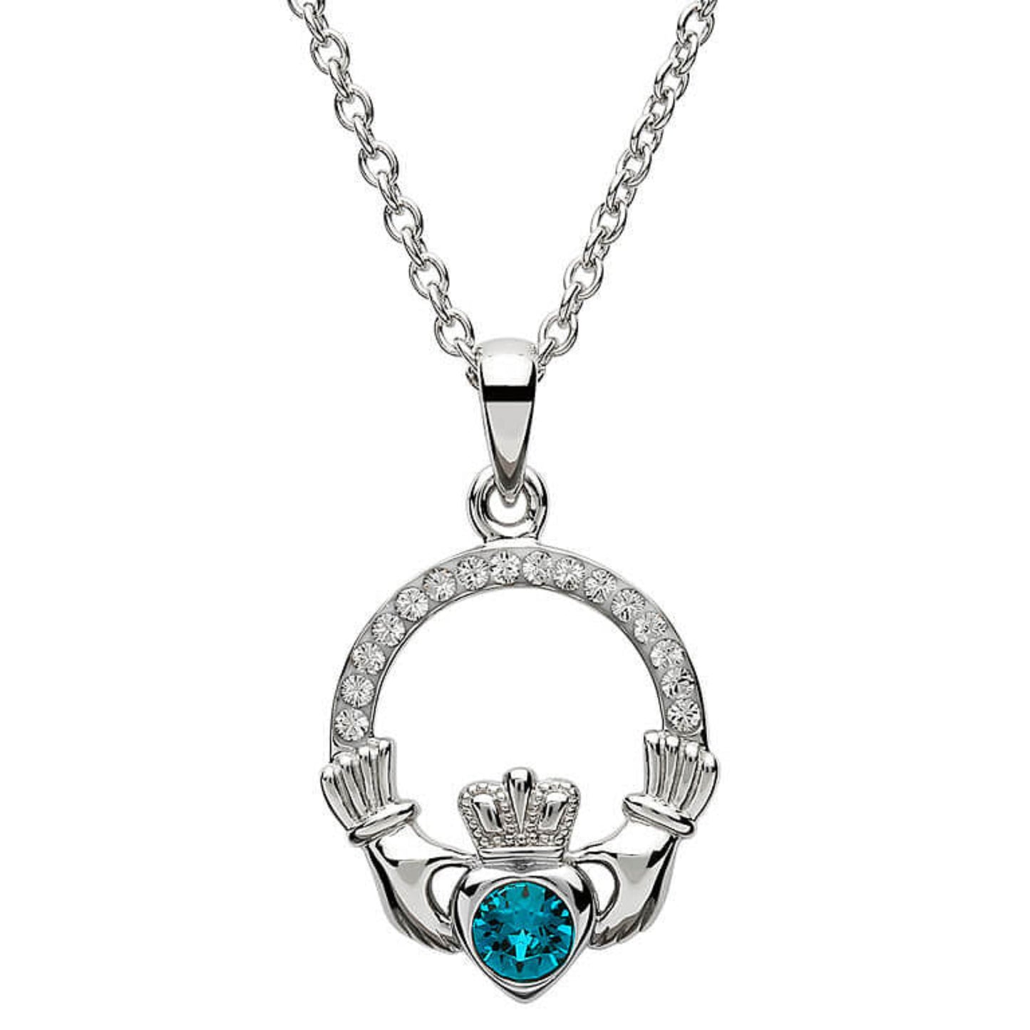 Silver claddagh pendant encrusted with white gems. The heart in the center contains one larger blue gem. 