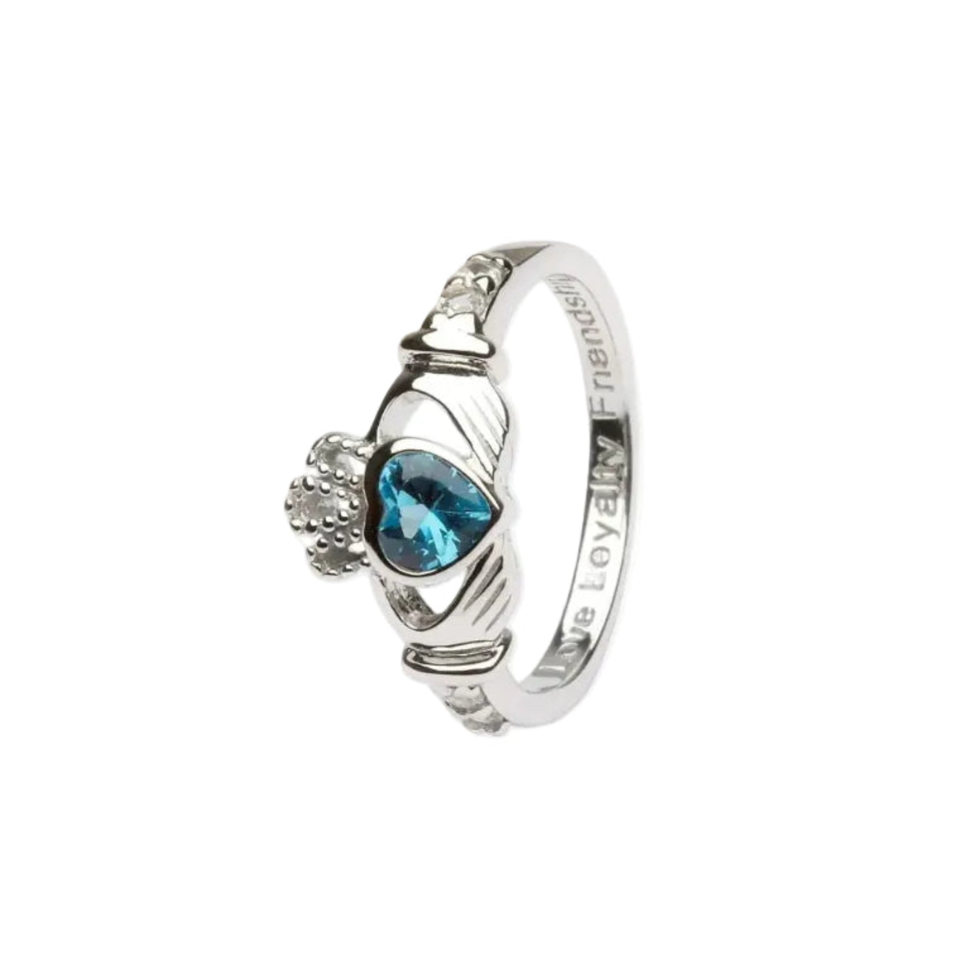 A sterling silver claddagh ring with a blue heart-shaped gem in the center.