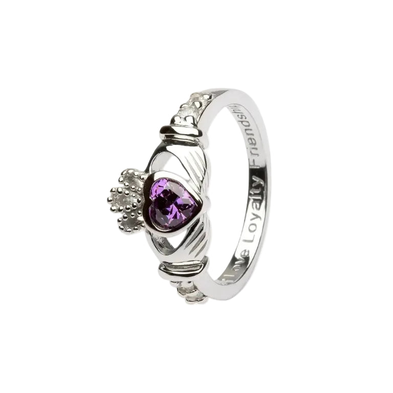 A sterling silver claddagh ring with a purple heart-shaped gem in the center.