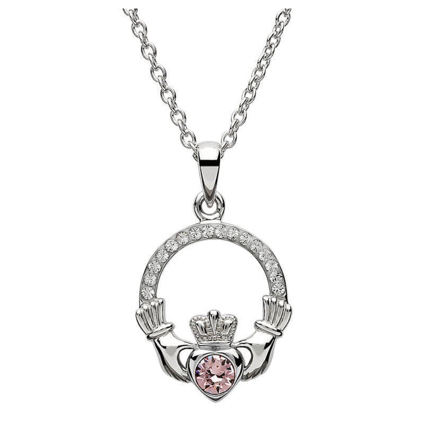 Silver claddagh pendant encrusted with white gems. The heart in the center contains one larger light pink gem. 