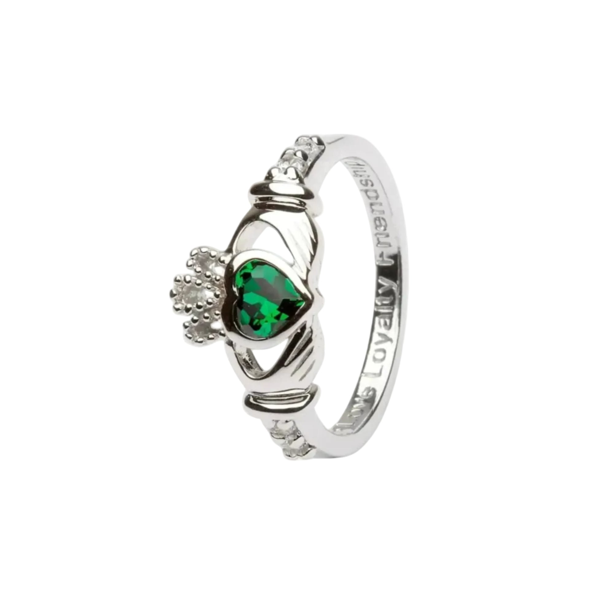 A sterling silver claddagh ring with a green heart-shaped gem in the center. 