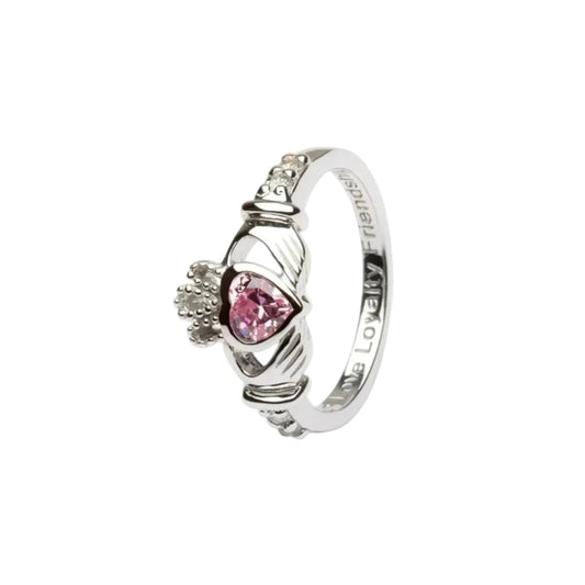 A sterling silver claddagh ring with a light pink heart-shaped gem in the center.