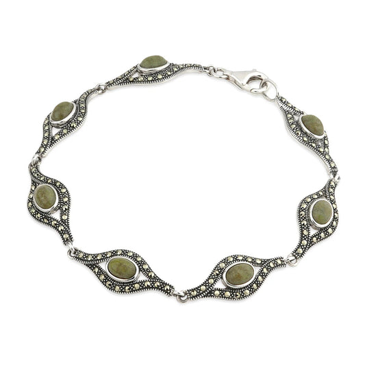A silver Claddagh links bracelet with green stones.