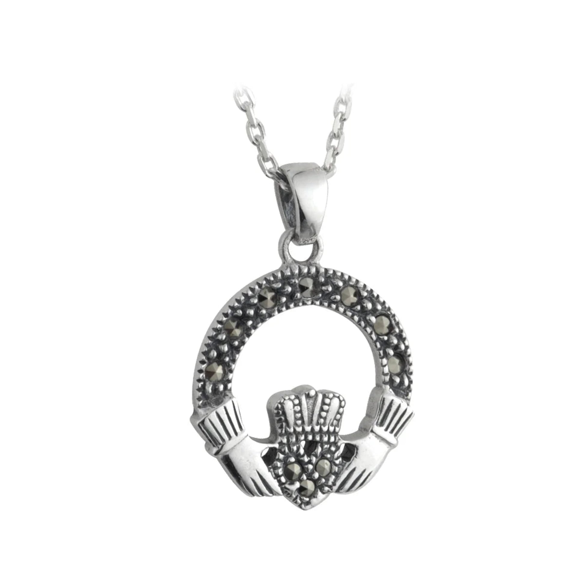 A silver pendant featuring a small claddagh design with marcasite stones.