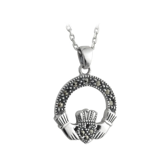 A silver pendant featuring a small claddagh design with marcasite stones.