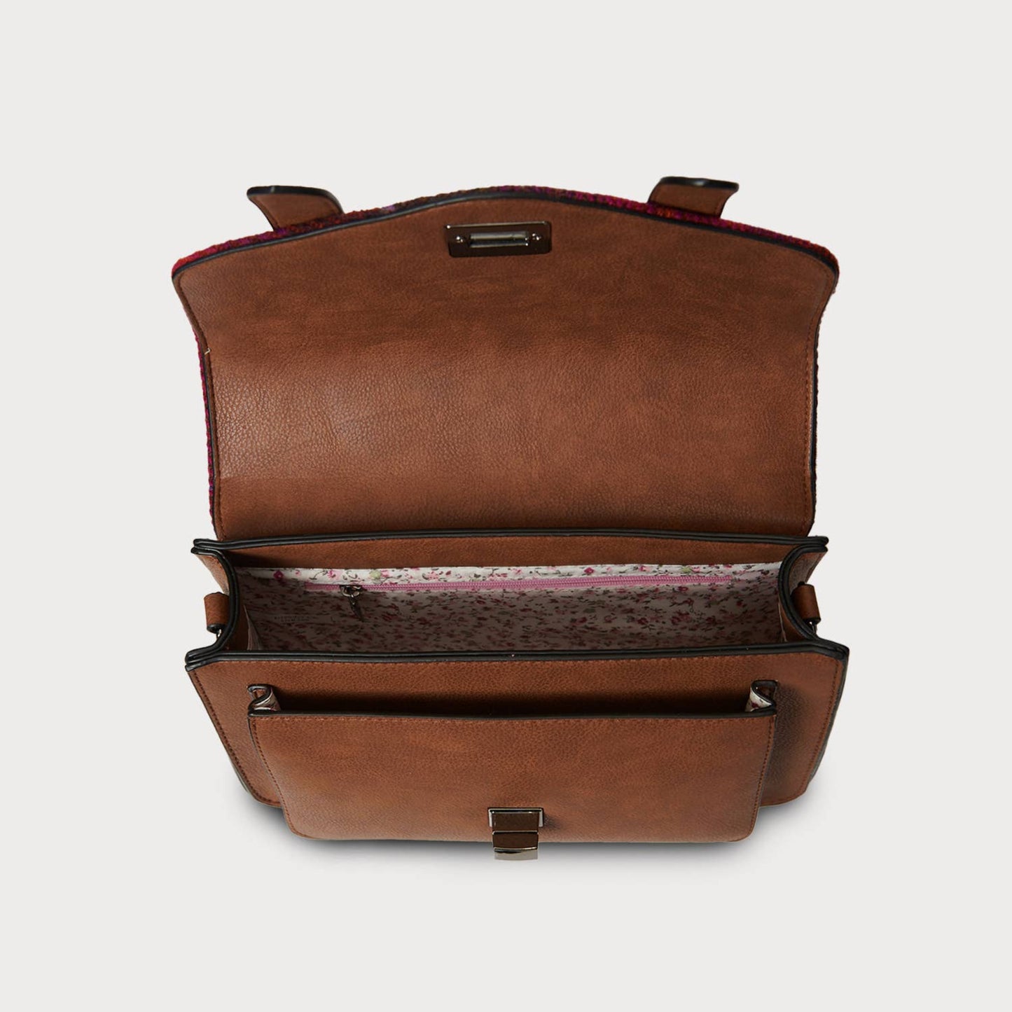 Brown leather bag with open front pocket on a light gray background
