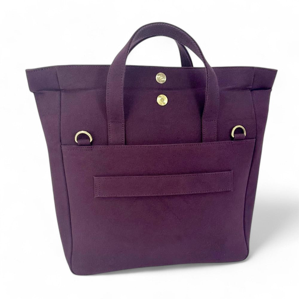 Purple tote bag with gold accents on a white background