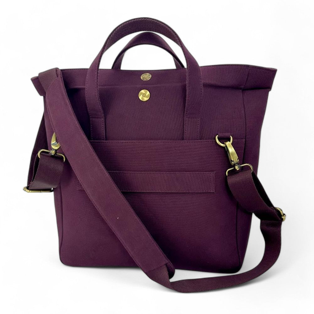 Purple tote bag with gold hardware on a white background