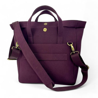 Purple tote bag with gold hardware on a white background