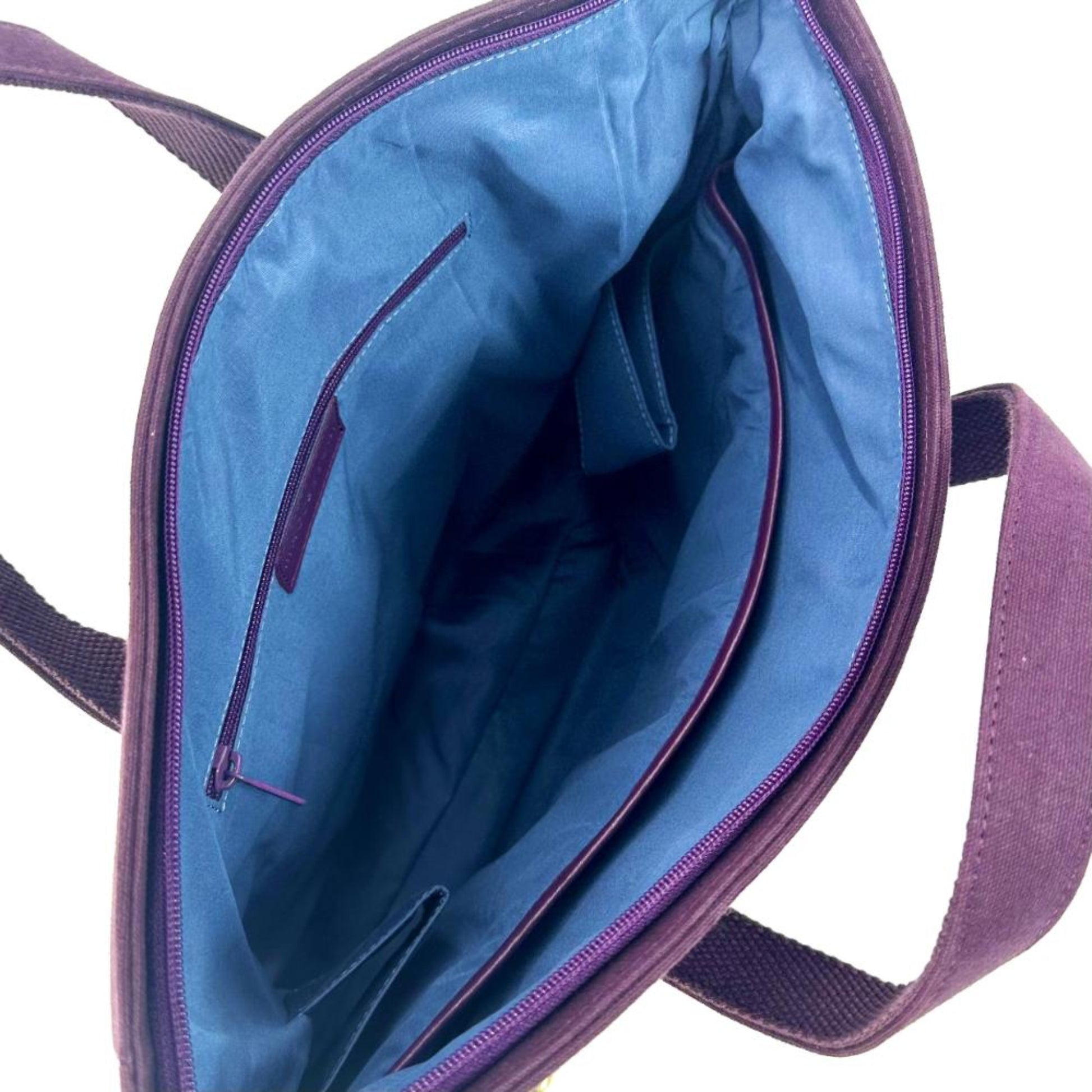 Purple and blue bag with open interior on a white background