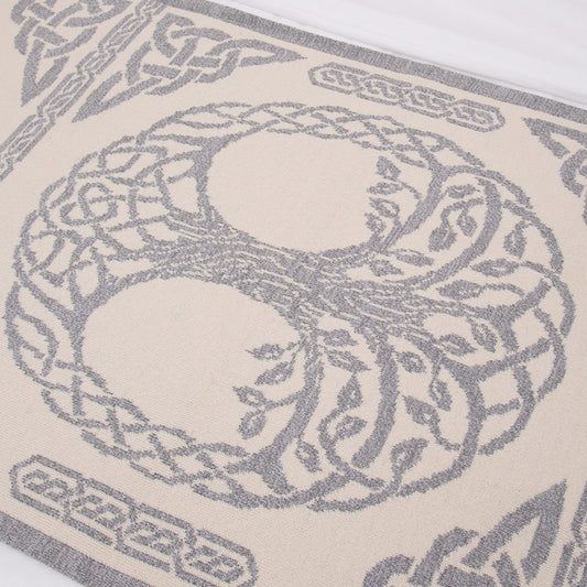 Close-up of a woven pattern with interlocking shapes on a beige background