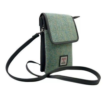 Green textured crossbody bag with a visible brand label on a white background