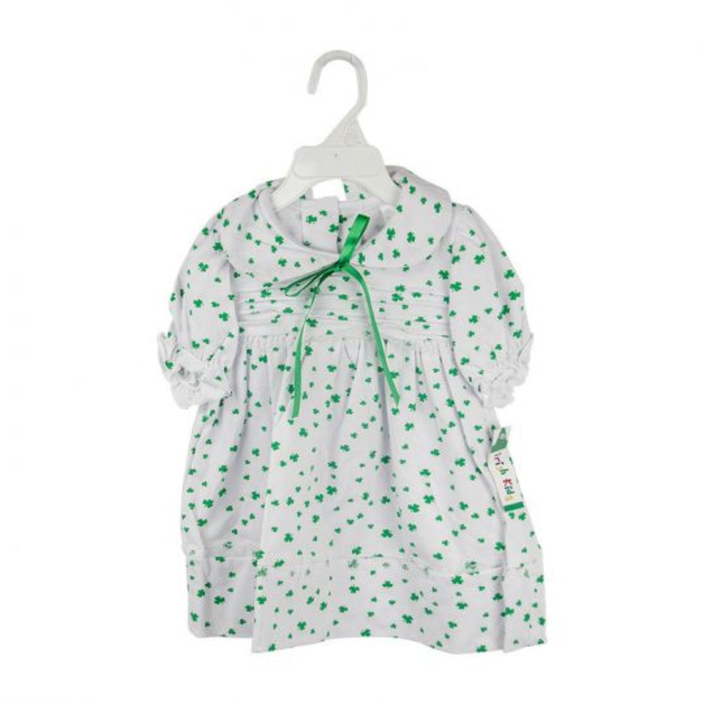 White dress with green floral pattern on a hanger against a white background