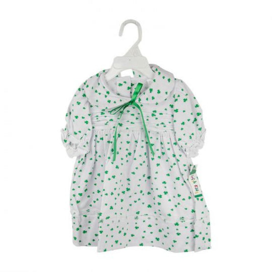 White dress with green floral pattern on a hanger against a white background