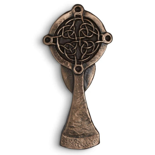 A bronze chalice-shaped cross with intricate knotwork embossment.